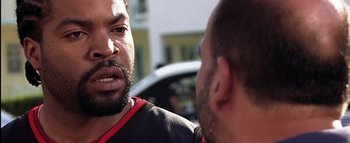 Movie still from “All About the Benjamins” (2002), directed by Kevin Bray – Two men talking to each other in front of a car; Close Up shot, Over the shoulder angle
