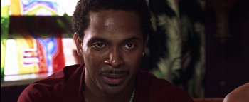 Movie still from “All About the Benjamins” (2002), directed by Kevin Bray – A person wearing a red shirt; Close Up shot, Over the shoulder angle