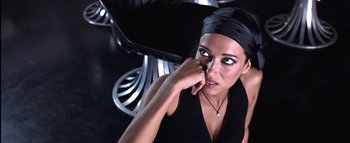 Movie still from “All About the Benjamins” (2002), directed by Kevin Bray – A woman in a black dress and a black head scarf; Close Up shot, High angle