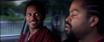 Movie still from “All About the Benjamins” (2002), directed by Kevin Bray – Two men sitting in the back seat of a car; Close Up shot, Over the shoulder angle