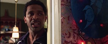 Movie still from “All About the Benjamins” (2002), directed by Kevin Bray – A person in a room near a wall; Close Up shot, Low angle