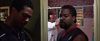 Movie still from “All About the Benjamins” (2002), directed by Kevin Bray – Two men are standing in front of a mirror; Medium shot, Over the shoulder angle