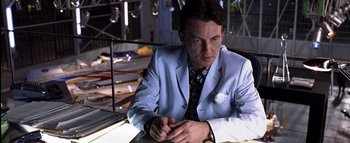 Movie still from “All About the Benjamins” (2002), directed by Kevin Bray – A man sitting at a table wearing a blue suit; Close Up shot, Low angle