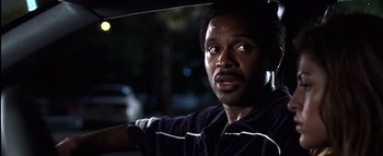 Movie still from “All About the Benjamins” (2002), directed by Kevin Bray – A person holding an open umbrella; Close Up shot, Low angle