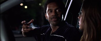 Movie still from “All About the Benjamins” (2002), directed by Kevin Bray – A person holding an umbrella; Close Up shot, Low angle