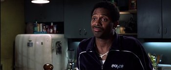 Movie still from “All About the Benjamins” (2002), directed by Kevin Bray – A person in a room with a bottle; Close Up shot, High angle