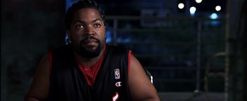 Movie still from “All About the Benjamins” (2002), directed by Kevin Bray – A person wearing a basketball uniform; Close Up shot, Over the shoulder angle