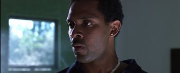 Movie still from “All About the Benjamins” (2002), directed by Kevin Bray – A person wearing a black shirt; Close Up shot, Low angle