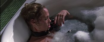 Movie still from “All About the Benjamins” (2002), directed by Kevin Bray – A woman in chains is laying on the floor; Close Up shot, High angle