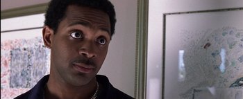 Movie still from “All About the Benjamins” (2002), directed by Kevin Bray – A person looking at a mirror; Close Up shot, Over the shoulder angle