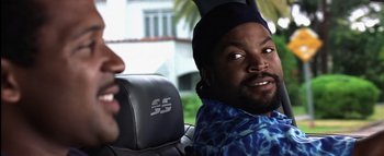 Movie still from “All About the Benjamins” (2002), directed by Kevin Bray – A man sitting in the back seat of a car; Close Up shot, Over the shoulder angle