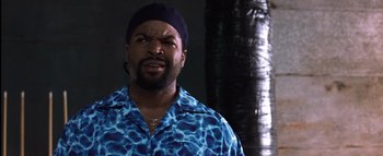 Movie still from “All About the Benjamins” (2002), directed by Kevin Bray – A man in a blue shirt and a black hat; Close Up shot, Over the shoulder angle