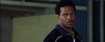 Movie still from “All About the Benjamins” (2002), directed by Kevin Bray – A person wearing a jacket and looking at the camera; Close Up shot, Low angle