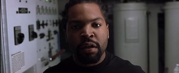 Movie still from “All About the Benjamins” (2002), directed by Kevin Bray – A person wearing a black shirt; Close Up shot, Low angle