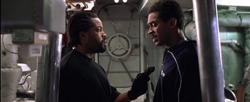 Movie still from “All About the Benjamins” (2002), directed by Kevin Bray – Two men are talking to each other in a room; Close Up shot, Over the shoulder angle