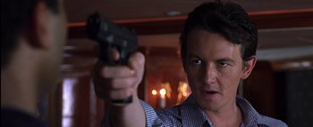 Movie still from “All About the Benjamins” (2002), directed by Kevin Bray – A man holding a gun in his right hand; Close Up shot, Low angle