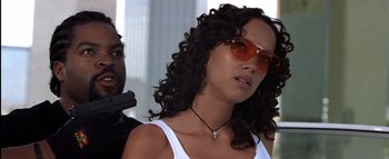 Movie still from “All About the Benjamins” (2002), directed by Kevin Bray – A woman wearing a white shirt and sunglasses; Close Up shot, Low angle