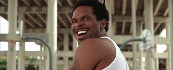 Movie still from “All About the Benjamins” (2002), directed by Kevin Bray – A person with a beard smiling; Close Up shot, Low angle