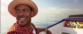 Movie still from “All About the Benjamins” (2002), directed by Kevin Bray – A man wearing a straw hat on a boat in the ocean; Close Up shot, Low angle