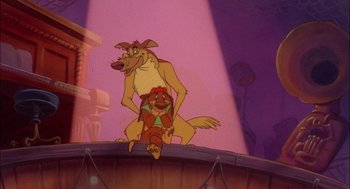 Movie still from “All Dogs Go to Heaven” (1989), directed by Dan Kuenster – A couple of dogs sitting next to each other on top of a platform; Wide shot, Low angle