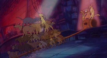 Movie still from “All Dogs Go to Heaven” (1989), directed by Dan Kuenster – A group of dogs are gathered together in a room; Wide shot, High angle