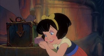 Movie still from “All Dogs Go to Heaven” (1989), directed by Dan Kuenster – A cartoon picture of a young girl holding a cell phone to her ear; Close Up shot, High angle