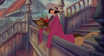 Movie still from “All Dogs Go to Heaven” (1989), directed by Dan Kuenster – A woman and a dog sitting on a railing in front of a building; Wide shot, High angle