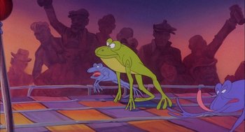Movie still from “All Dogs Go to Heaven” (1989), directed by Dan Kuenster – A cartoon of a frog standing on a platform with a crowd of people in the background; Wide shot, High angle