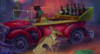 Movie still from “All Dogs Go to Heaven” (1989), directed by Dan Kuenster – A dog sitting in the back of an old red truck; Wide shot, High angle