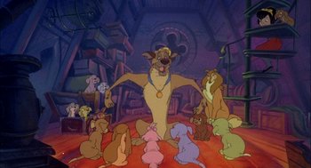 Movie still from “All Dogs Go to Heaven” (1989), directed by Dan Kuenster – A group of dogs sitting in a room with a dog trainer; Wide shot, High angle