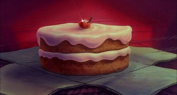 Movie still from “All Dogs Go to Heaven” (1989), directed by Dan Kuenster – A cake that has a cherry on top of it; Extreme Close Up shot, High angle