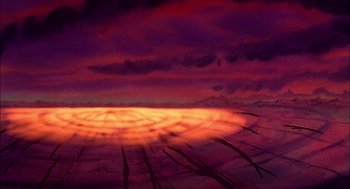 Movie still from “All Dogs Go to Heaven” (1989), directed by Dan Kuenster – The sun is setting in the middle of the desert; Extreme Wide shot, Overhead angle