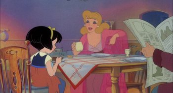 Movie still from “All Dogs Go to Heaven” (1989), directed by Dan Kuenster – A woman sitting at a dinner table with a child; Medium shot, Over the shoulder angle