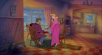 Movie still from “All Dogs Go to Heaven” (1989), directed by Dan Kuenster – A woman in a pink dress stands at a dining room table; Wide shot, High angle