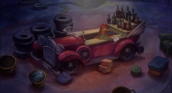 Movie still from “All Dogs Go to Heaven” (1989), directed by Dan Kuenster – A painting of a dog in a red car with bottles on top of it; Wide shot, High angle
