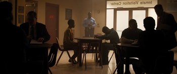 A group of people sitting at a table in a room