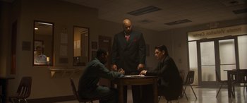 A group of men sitting at a table in a room