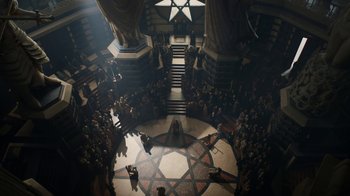 Movie still from “Game of Thrones” (2011), created by D.B. Weiss – A group of people standing in a circle in front of a building; Extreme Wide shot, Overhead angle