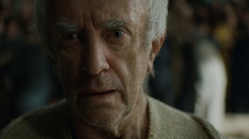 Movie still from “Game of Thrones” (2011), created by D.B. Weiss – An old man with a white beard looking at the camera; Close Up shot, Low angle