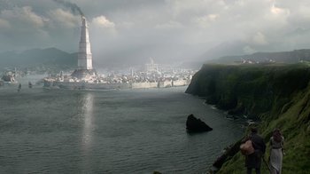 Movie still from “Game of Thrones” (2011), created by D.B. Weiss – A view of a city from the shore of a body of water; Extreme Wide shot, High angle