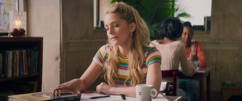 Movie still from “All My Life” (2020), directed by Marc Meyers – A woman sitting at a table with a cup in front of her; Medium shot, Over the shoulder angle