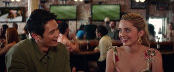 Movie still from “All My Life” (2020), directed by Marc Meyers – A man and a woman sitting in front of a television; Medium shot, Over the shoulder angle