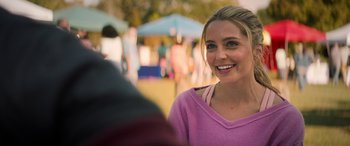 Movie still from “All My Life” (2020), directed by Marc Meyers – A beautiful young lady smiling at the camera; Close Up shot, Over the shoulder angle