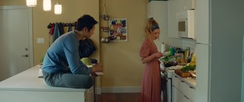 Movie still from “All My Life” (2020), directed by Marc Meyers – A man and a woman in a kitchen preparing food; Medium shot, High angle