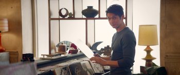 Movie still from “All My Life” (2020), directed by Marc Meyers – A man holding a sheet of paper in front of a window; Medium shot, Over the shoulder angle