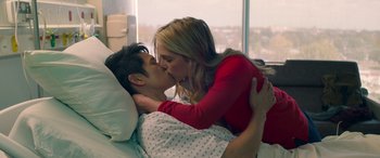 Movie still from “All My Life” (2020), directed by Marc Meyers – A man and a woman kissing in a hospital bed; Medium shot, Overhead angle