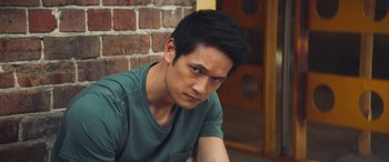 Movie still from “All My Life” (2020), directed by Marc Meyers – A person sitting on the ground near a brick wall; Close Up shot, Over the shoulder angle