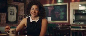 Movie still from “All My Life” (2020), directed by Marc Meyers – A woman sitting at a table in front of a chalkboard; Close Up shot, Over the shoulder angle