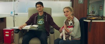 Movie still from “All My Life” (2020), directed by Marc Meyers – A man and a woman sitting in a chair with a dog; Medium shot, Over the shoulder angle