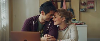 Movie still from “All My Life” (2020), directed by Marc Meyers – A man and a woman sitting in front of a laptop computer; Medium shot, Over the shoulder angle
